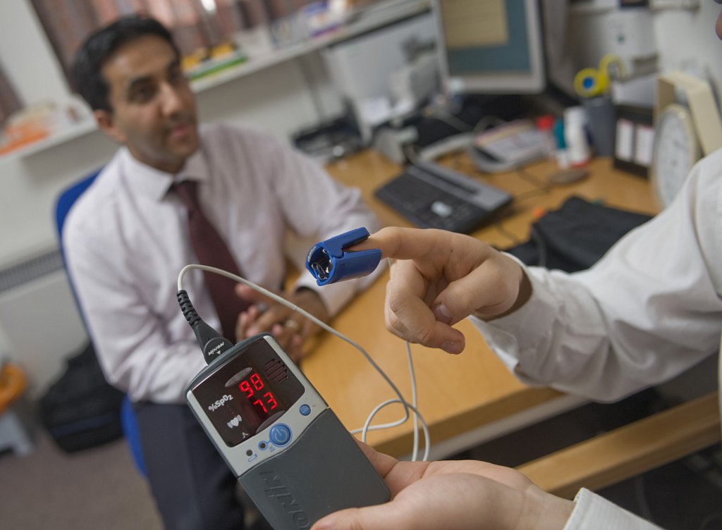 Asian GP in his NHS Surgery